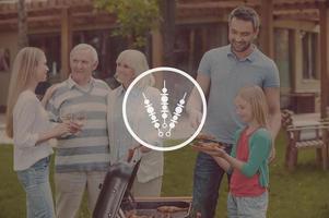 Barbecue time. Happy family of five people barbecuing meat on grill on the back yard photo