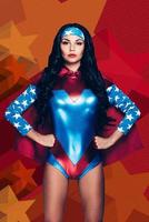 Evil can not handle with her. Beautiful young woman in superhero costume looking at camera and keeping hands on hips while standing against colorful background photo