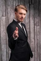 Confident in his style. Handsome young man in formalwear pointing you photo