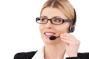 How may I help you Confident mature customer service representative adjusting her headset and smiling while standing isolated on white photo