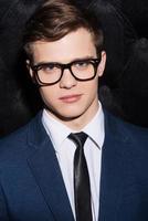 Confident handsome. Portrait of handsome young man wearing eyewear and looking at camera photo