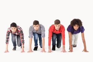 People on starting line. Group of young multi-ethnic men standing on starting line and looking forward while isolated on white photo