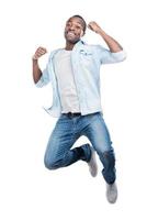 I did it Full length of handsome young black man jumping against white background photo