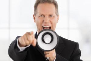 Yes, You Portrait of confident mature man in formalwear shouting at megaphone and pointing camera photo