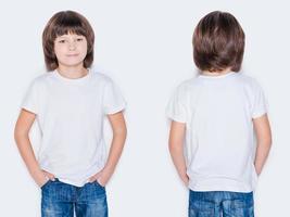 Advertising your brand. Front and rear view of little boy holding hands in pockets while standing against white background photo