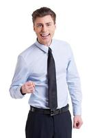 I did it Handsome young man in shirt and tie looking at camera and gesturing while standing isolated on white photo