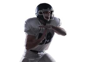 Time out requirement.  American football player screaming and showing time out while standing against white background photo