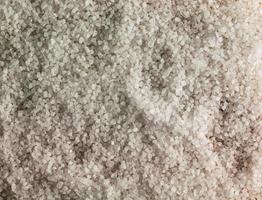 Background of coarsely ground salt. Close-up. Texture of sea salt for food seasoning photo