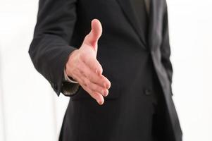 Welcome on board Close-up of businessman stretching out hand for handshake photo