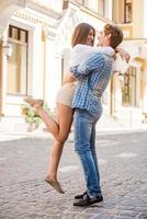 Happy loving couple. Full length of beautiful young loving couple hugging and looking at each other while standing outdoors photo
