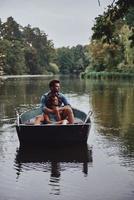 Quite moments. Beautiful young couple embracing while enjoying romantic date on the lake photo