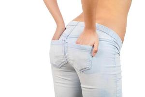 Hands in pockets. Close-up rear view of woman holding hand in jeans pockets photo