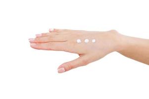 Keeping her skin young and smooth. Close-up of woman with cream dots on hand photo