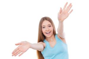 Focus on me Cheerful teenage girl woman stretching out hands and smiling while standing isolated on white photo