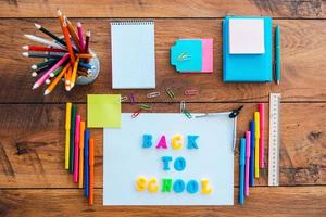 Back to school. Top view of school stuff laying on the wooden table photo