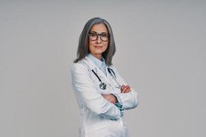 Mature beautiful female doctor looking at camera and smiling photo