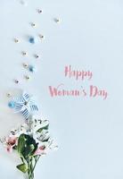 Happy womens day High angle shot of flowers lying against white background photo