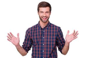 Happy handsome. Happy young man in casual shirt gesturing and smiling while standing isolated on white photo