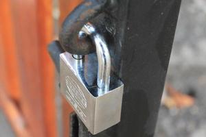 padlock hanging on the fence photo