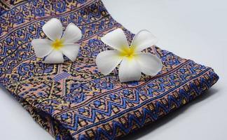 Frangipani flowers on cloth photo