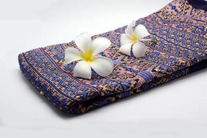 Frangipani flowers on cloth photo