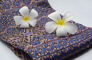 Frangipani flowers on cloth photo