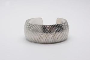 Metal bracelet on white photo