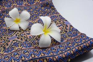 Frangipani flowers on cloth photo