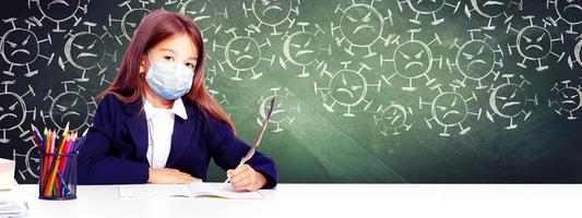 Young girl with protection mask against corona virus at school. photo