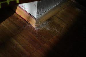 Corner in room. Baseboard on floor. Dust in corner of wall. photo