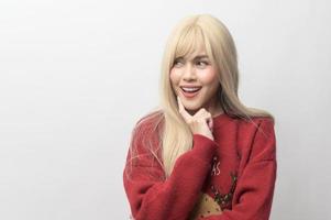 Portrait of happy Caucasian young woman in Christmas sweater over white background photo