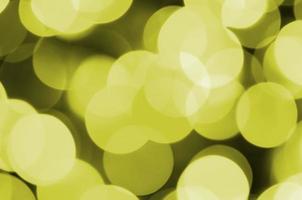 Bokeh effect golden yellow defocused light background. Christmas Lights Concept photo