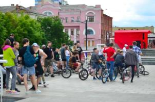 Defocused image of a lot of people with bmx bikes. Meeting of fans of extreme sports photo