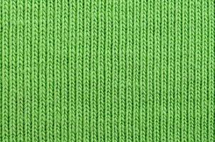 The texture of the fabric is bright green. Material for making shirts and blouses photo