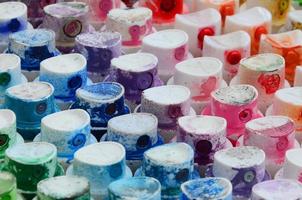 A pattern from a many nozzles from a paint sprayer for drawing graffiti, smeared into different colors. The plastic caps are arranged in many rows forming the color of the rainbow photo