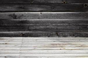 Free space above the wooden surface against the background of a dark wooden wall photo