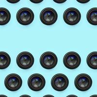 A few camera lenses with a closed aperture lie on texture background of fashion pastel blue color paper photo