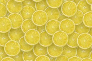 Pattern of yellow lemon citrus slices. Citrus flat lay photo