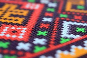 Traditional Ukrainian folk art knitted embroidery pattern on textile fabric photo