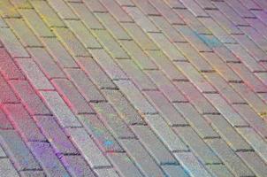 Multi colored paving slabs, powder coated with dry colors at the Holi festival photo