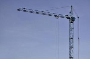 Tower crane against a blue sky photo