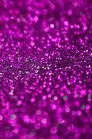 Pink decorative sequins. Background image with shiny bokeh lights from small elements photo