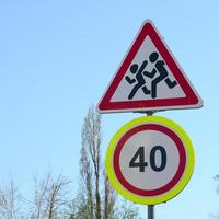 Road sign with the number 40 and the image of the children who run across the road photo