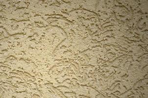 The texture of the beige decorative plaster in bark beetle style photo