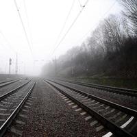 The railway track in a misty morning. A lot of rails and sleepers go into the misty horizon. Fisheye photo with increased distortion