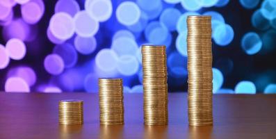 Golden coin stacks arranged as a graph. Increasing columns of coins photo