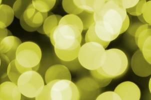 Bokeh effect golden yellow defocused light background. Christmas Lights Concept photo