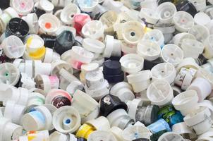 A pattern of many used and soiled nozzles from spray cans with aerosol paint. Background texture of the street art of drawing graffiti on the walls photo