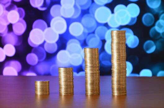 Golden coin stacks arranged as a graph. Increasing columns of coins photo