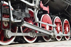 Red wheels of steam train photo